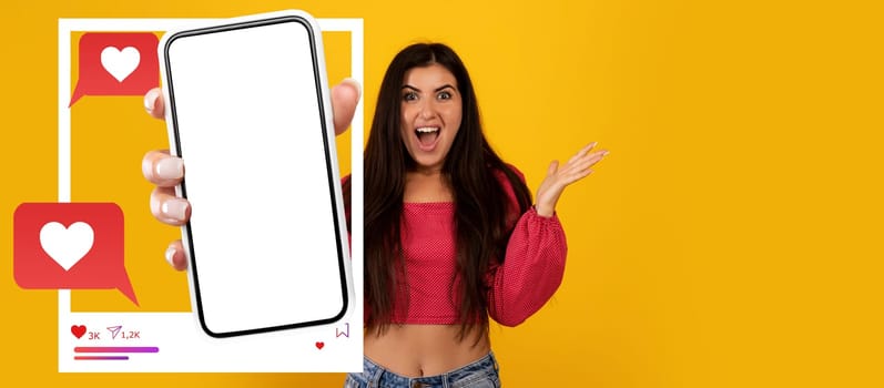 An enthusiastic influencer excitedly holds a smartphone displaying a blank screen for a social media application.