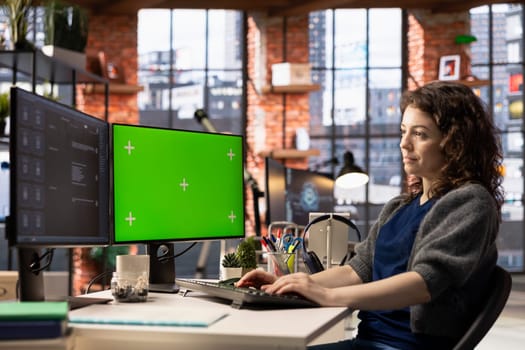 Focused person interacting with a chatbot interface next to chroma key, AI system leverages machine learning and automation to generate helpful responses. Improve online data driven workflow.