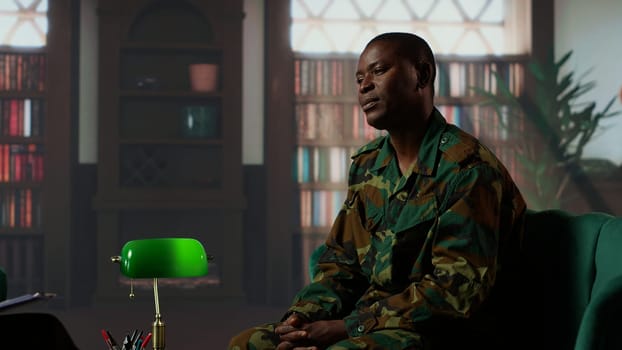 Military personnel in therapy confronting war related anxiety and psychological issues, infantry shell shock syndrome. Army soldier listening to professional advice from counselor. Camera B.