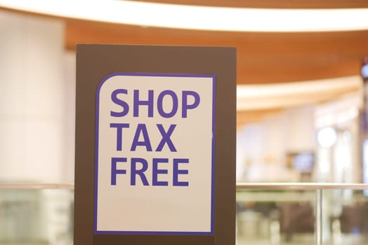 A sign promoting tax-free shopping is prominently displayed indoors.