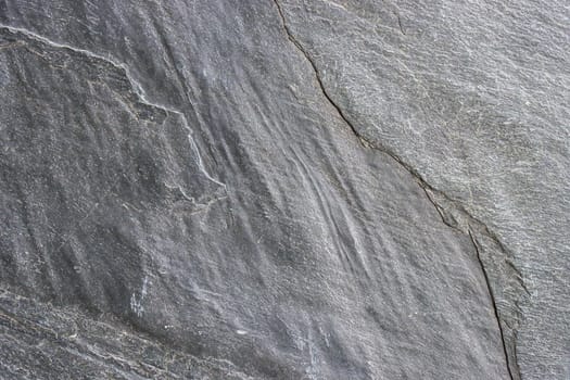 The surface of a granite stone painted gray. Abstract background for design.