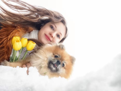 A mother and daughter share a happy moment as they walk through a sunny field filled with dandelions and blooming flowers, creating joyful memories.