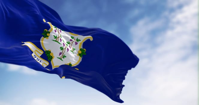 Close-up view of the Connecticut state flag fluttering. White shield on blue background featuring three grapevines each bearing bunches of grapes. 3d illustration render. Selective focus