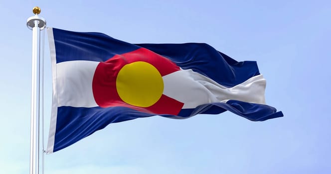 Colorado state flag waving in the wind on a clear day. Three blue, white, and blue stripes. Red C with gold disk on top. 3D illustration render. Fluttering fabric. Selective focus