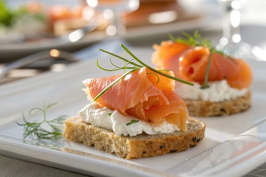 Appetizer displays slices of smoked salmon elegantly arranged on cream cheese spread atop toasted whole grain bread. Garnished with fresh herbs, this dish invites tasting and sharing.