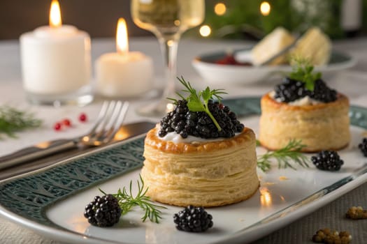 Delicate puff pastry towers topped with creamy filling and fresh blackberries are beautifully arranged on a plate.