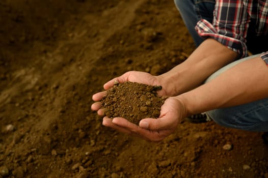 Farmer inspecting soil texture and composition, preparing for planting.