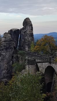 Ancient stone bridge shotlisttravel building architecture opendoor nature reserve park green autumn summer day shotlisttravel travel tourism sky landscape background trees . photo evening rock forest
