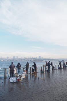 Fishermen cast lines as clouds gather along the waterfront.