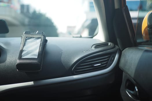 Inside a car with pos machine on the dashboard ,