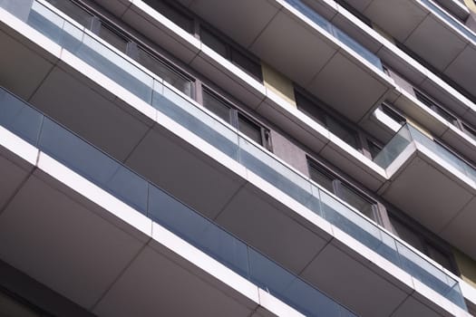 A contemporary residential structure with multiple levels and glass balconies.