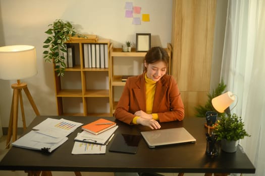 Smiling young entrepreneur working in a cozy office.