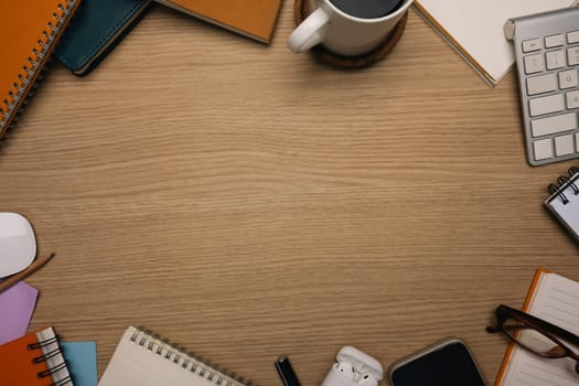 Top view of wooden work desk with blank space for text.