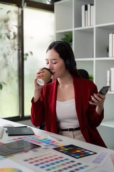 Capturing a moment of reflection, this image shows a designer enjoying coffee, immersed in thoughts about color and design in a modern workspace.
