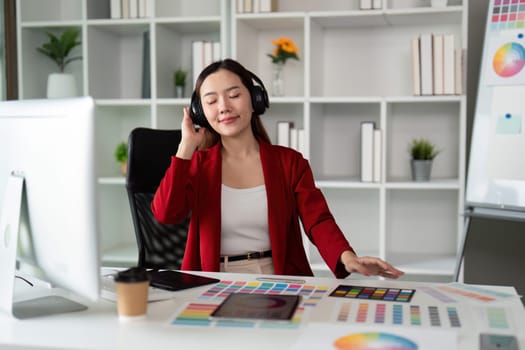 The designer enjoys listening to music while working on her projects, creating a vibrant atmosphere of inspiration and focus.
