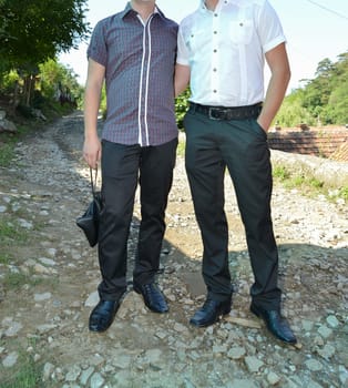A group of people stand side by side, each wearing distinct formalwear, sharing in the spirit of the occasion