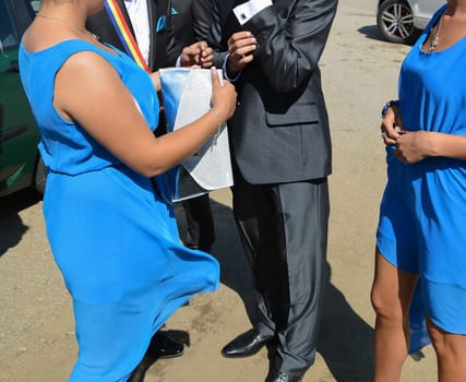 A stylish gathering featuring vibrant blue dresses and formal shoes, capturing the essence of celebration.