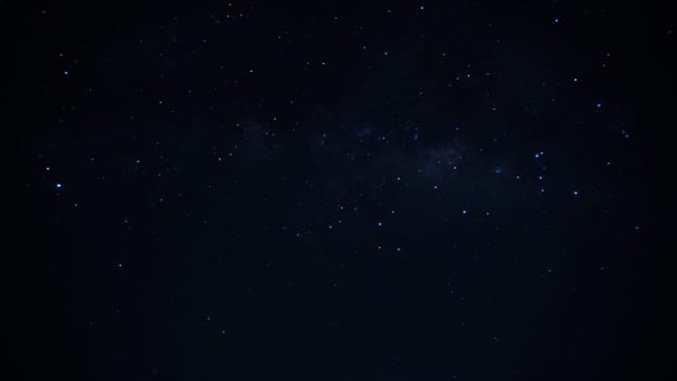 Shining brightly, the milky way galaxy illuminates the dark night sky, surrounded by countless twinkling stars, forming a breathtaking and serene cosmic scene filled with wonder