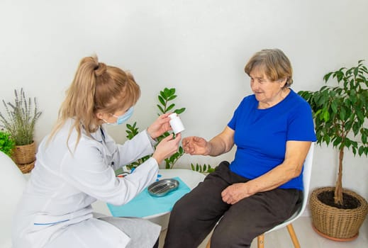 Elderly woman at a doctor appointment. Selective focus. People.