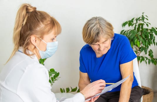 Elderly woman at a doctor appointment. Selective focus. People.