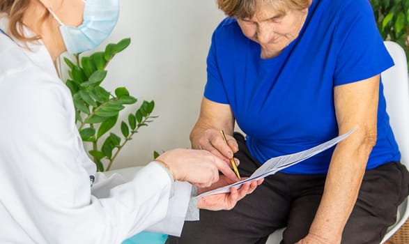 Elderly woman at a doctor appointment. Selective focus. People.