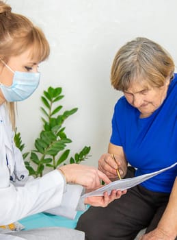 Elderly woman at a doctor appointment. Selective focus. People.