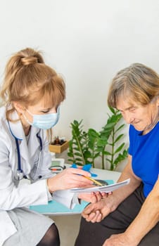 Elderly woman at a doctor appointment. Selective focus. People.