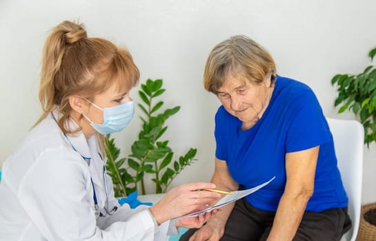 Elderly woman at a doctor appointment. Selective focus. People.