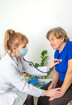 Elderly woman at a doctor appointment. Selective focus. People.