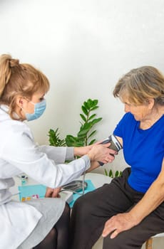 Elderly woman at a doctor appointment. Selective focus. People.