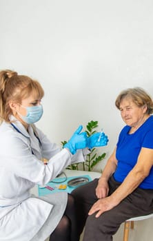 Elderly woman at a doctor appointment. Selective focus. People.