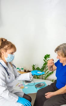 Elderly woman at a doctor appointment. Selective focus. People.