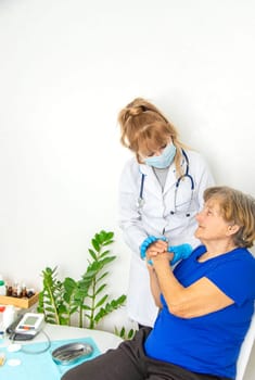 Elderly woman at a doctor appointment. Selective focus. People.
