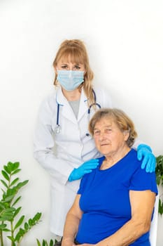 Elderly woman at a doctor appointment. Selective focus. People.