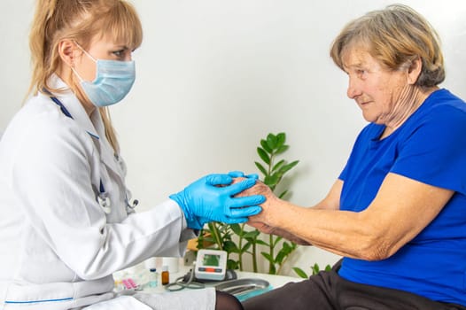 Elderly woman at a doctor appointment. Selective focus. People.