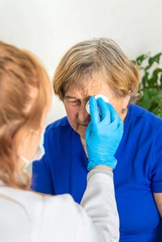 Elderly woman at a doctor appointment. Selective focus. People.
