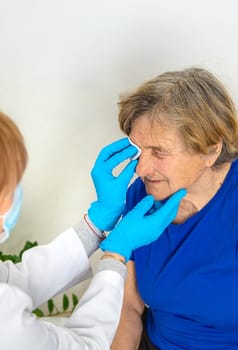 Elderly woman at a doctor appointment. Selective focus. People.