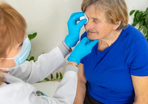 Elderly woman at a doctor appointment. Selective focus. People.