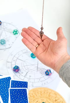 Pendulum fortune telling and astrology. Selective focus. people.