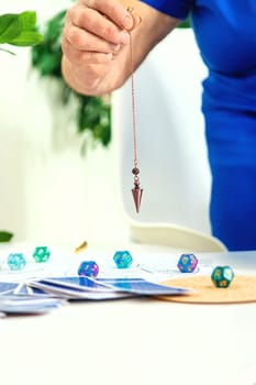 Pendulum fortune telling and astrology. Selective focus. people.