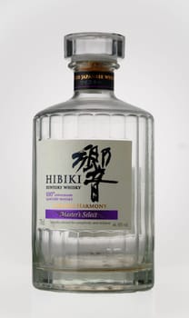 Gaziveren Cyprus -17.03.2025 A beautifully crafted bottle of Japanese whisky Hibiki sits elegantly on a wooden table, catching the warm rays of the setting sun, inviting connoisseurs to explore its rich flavors and heritage.
