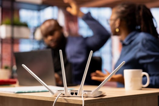 Irritated African American man struggling to reach the internet provider to help fix the signal loss issues, freelancers working at home with an unstable Wi Fi connection. Troubleshooting.