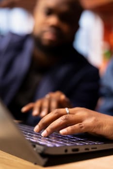 African american couple working remotely in their apartment, planning business strategies and discussing project development while using a laptop to track progress and ensure success.