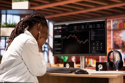 Sad day trader reacting with frustration after losing money in cryptocurrency investment due to rug pull. Upset woman suffering emotional toll of financial loss after trading plummeting crypto coin