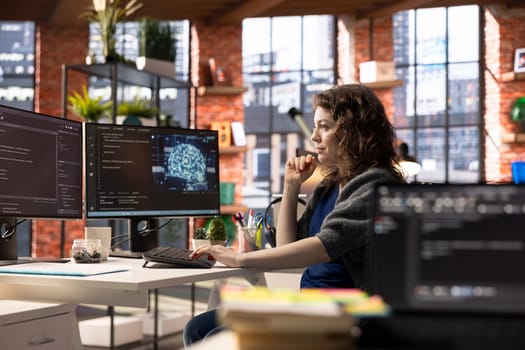Admin writing code on PC and doing maintenance on artificial intelligence neural networks computerized model. Woman tech support expert doing checkup on AI systems, data science.
