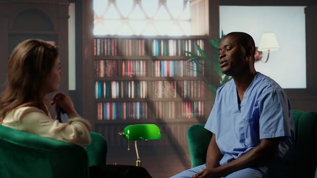 Black nurse in therapy addressing anxiety and post traumatic stress from a career in the hospital, assistant seeks help for PTSD and depression after losing patients, burnout. Camera B.