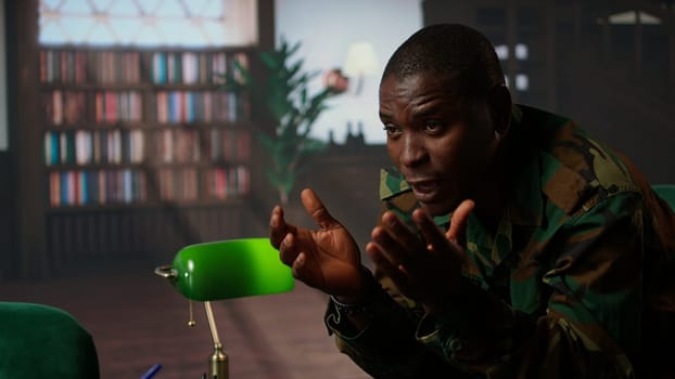 Therapist offering help to army soldier during psychotherapy session, suffering from bipolar disorder and shell shock due to war flashbacks. Distraught military personnel deals with PTSD. Camera A.