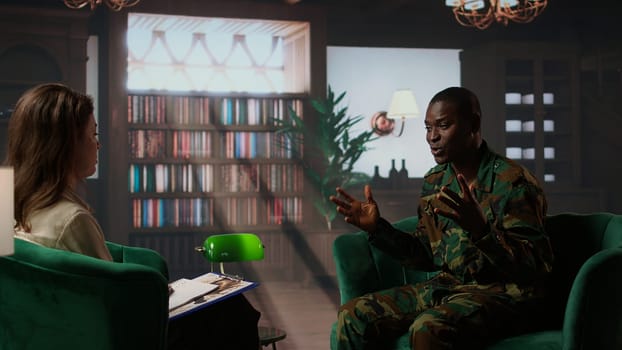 African american soldier deals with a serious case of shell shock, experiencing guilt and anxiety due to traumatic war experiences. Armed forces trooper sharing his feelings at therapy. Camera A.