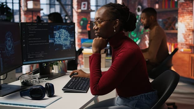 Programmer coding artificial intelligence algorithm in startup, refining machine learning models to enhance automation and data driven decision making. Woman using coding platform in office, camera A