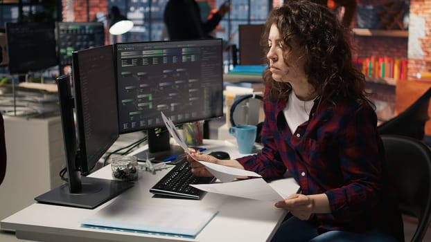 Tech venture business HR employee looking at CVs, doing talent acquisition for potential job applicants. Woman reading resumes of candidates for software development vacant position, camera A